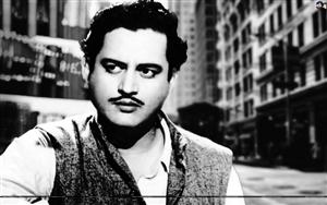 Guru Dutt, a famous Indian film director, producer and actor, in a black and white shot